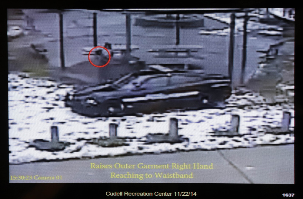 This still image taken from a surveillance video played at a news conference held by Cleveland Police, Wednesday, Nov. 26, 2014, shows Cleveland police officers arriving at Cudell Park on a report of a man with a gun.
