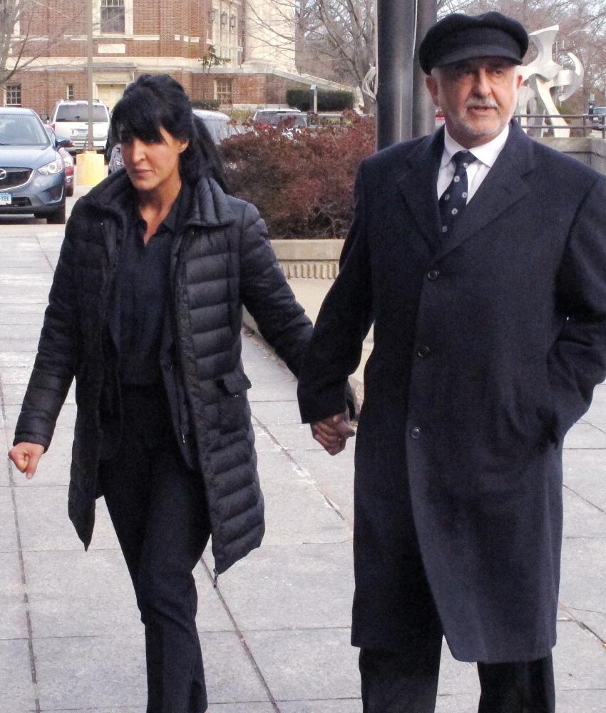 Tiffany Stevens walks with her father, Edward Khalily, to Hartford Superior Court in Hartford, Conn., on Tuesday. The alleged murder-for-hire plot in 2012 occurred as she and her ex-husband were involved in a child custody dispute.