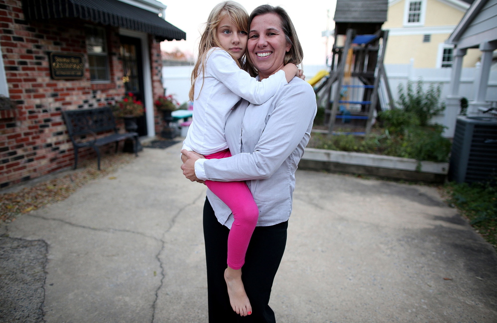 Peggy Young holds her daughter Triniti, 7, in Arlington, Virginia. Peggy Young is at the heart of an upcoming Supreme Court case on pregnancy discrimination. Both women’s rights supporters and anti-abortion groups see the case as central to establishing equal access to the workplace for women.