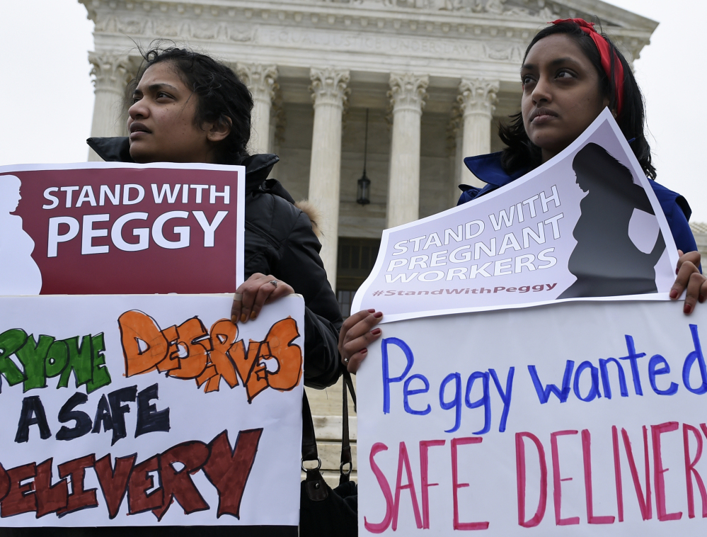 Supporters of Peggy Young, a UPS driver who lost her job when she asked for lighter duty related to pregnancy, attend a rally in Washington Wednesday.