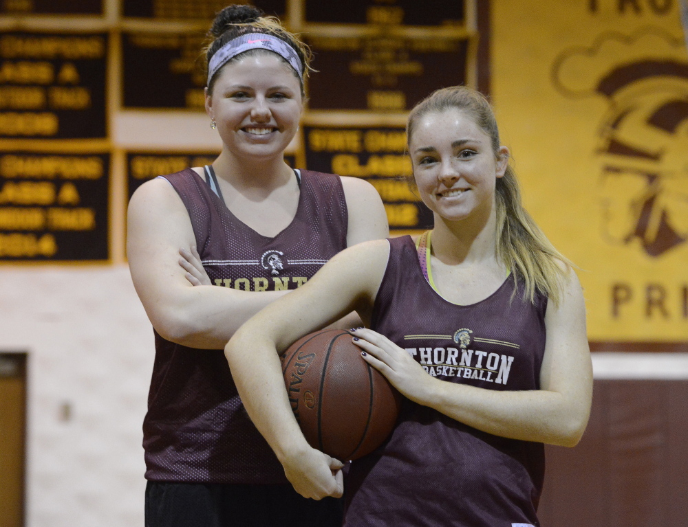 Victoria Lux, left, and Katie McCrum played together on the Maine Firecrackers AAU team. Now they’re teammates at Thornton Academy, with Lux transferring from McAuley, where she helped win three state titles.