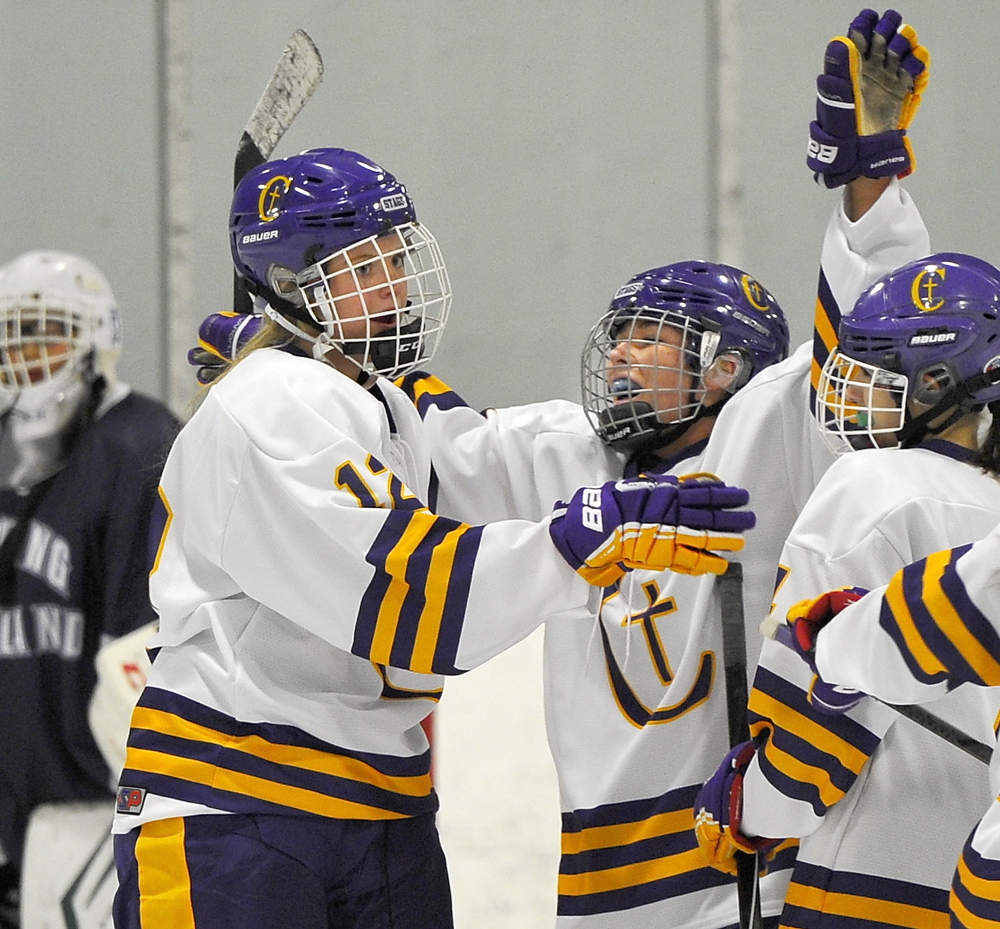 Caroline Ray, left, and Jill Hannigan of Cheverus celebrate Wednesday following a goal during an 8-2 victory against Portland/Deering in a schoolgirl hockey game at the Portland Ice Arena.