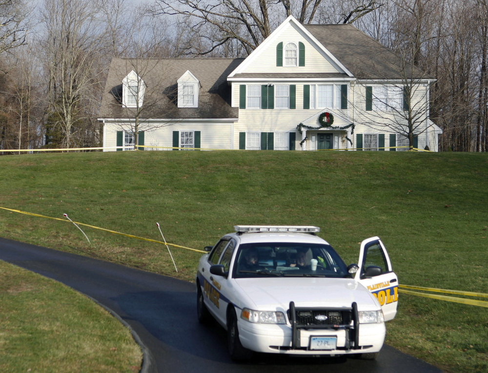 A police cruiser sits in the driveway of the Newtown, Conn., home where Sandy Hook Elementary School gunman Adam Lanza lived with his mother on Dec. 18, 2012.