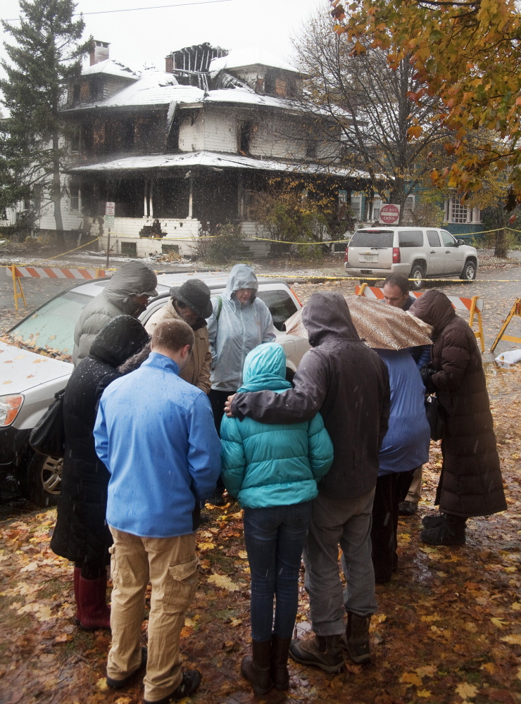 People gather across from 20 Noyes St. the day after the fire on Nov. 1 killed six people. It was Maine’s deadliest fire in 40 years. Landlord Gregory Nisbet has not responded to repeated requests for comment about his management of the duplex, and his attorney has declined to comment.
