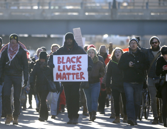 Protesters march in Minneapolis on Thursday, a day after a grand jury decided not to indict a New York City officer in the death of Eric Garner.
