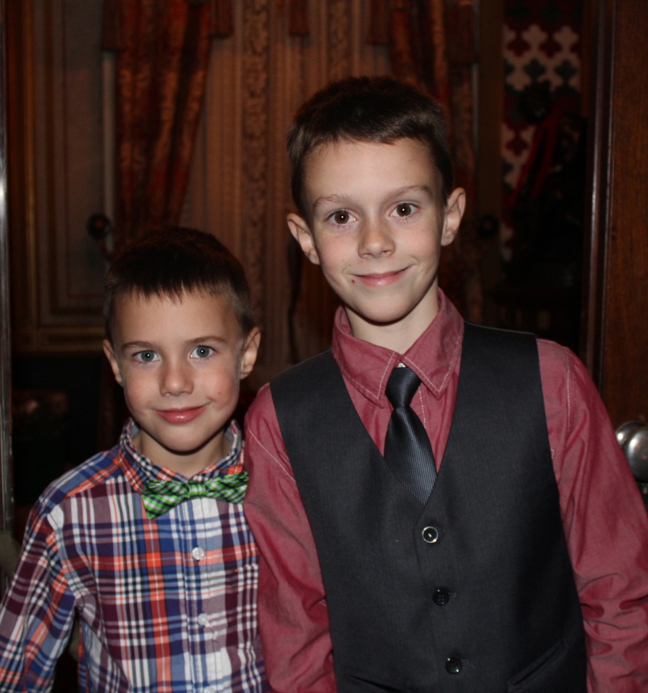 Brothers Ben and Jack Caron, whose mother Heather Caron designed the holiday decor for the staircase.