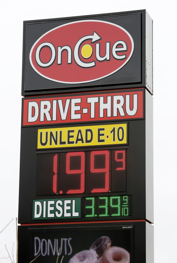 A sign displays the price for E-10 gasoline for $1.99 at the OnCue convenience store and gas station Wednesday in Oklahoma City. The Associated Press