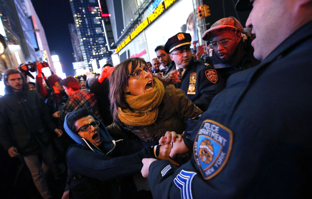 Police arrest protesters attempting to block traffic near Times Square in New York this week after a grand jury decided not to indict the police officer involved in the death of Eric Garner. “Police officers feel like they are being thrown under the bus,” said Patrick Lynch, president of the police union.