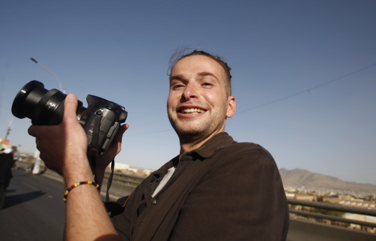 Luke Somers, 33, an American photojournalist who was kidnapped over a year ago by al-Qaida, poses for a picture during a parade marking the second anniversary of the revolution in Sanaa, Yemen in February, 2013. Somers was killed Saturday in a failed rescue attempt.