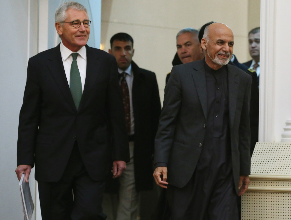 Afghan President Ashraf Ghani, right and and U.S. Secretary of Defense Chuck Hagel walk into a news conference at the Presidential Palace on Saturday in Kabul, Afghanistan. Defense Secretary Hagel spoke about troop withdrawal in Afghanistan and the recent failed attempt to rescue an American hostage in Yemen.