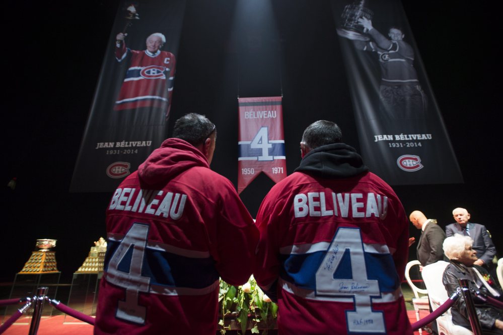Mourners file past the casket to pay their respect during the public viewing for the Montreal Canadiens legend Jean Beliveau on Sunday in Montreal.