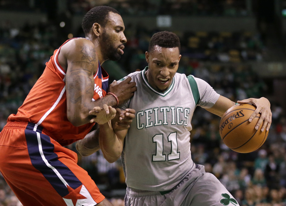 Guard Evan Turner of the Celtics tries to drive past Washington’s Rasual Butler in the second quarter Sunday in Boston. The Celtics won 101-93 for their third straight win.