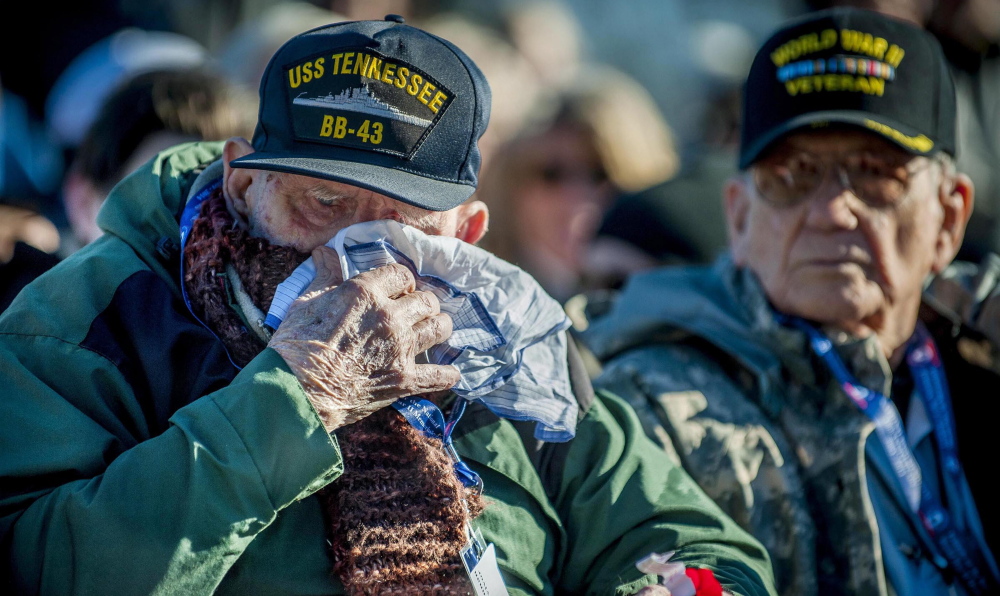 U.S. Navy veteran Robert MacLennan, 92, of Sanford, Va, wipes a tear after being presented a flower during a Pearl Harbor remembrance service in Washington. “In a way, I feel honored,” he said, “but in another way, it gives you nightmares.”