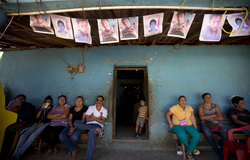 People gather outside of the home of Alexander Mora, one of 43 college students missing since September whose charred remains have now been positively identified among those found near a garbage dump in the town of El Pericon, Mexico.
