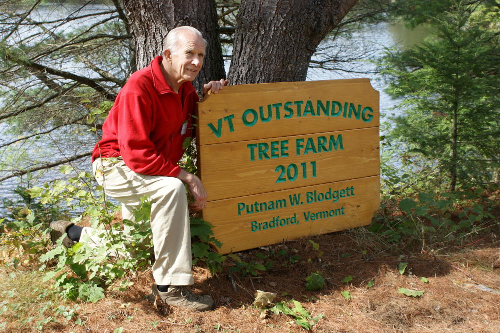 Putnam “Put” Blodgett of Bradford, Vermont, poses by a sign announcing he was named Vermont’s 2011 Outstanding Tree Farmer. Blodgett, president of the Vermont Woodlands Association, has created a plan to sustain his 670 acres of family-owned forestland by forming a limited liability company and establishing a conservation easement.
