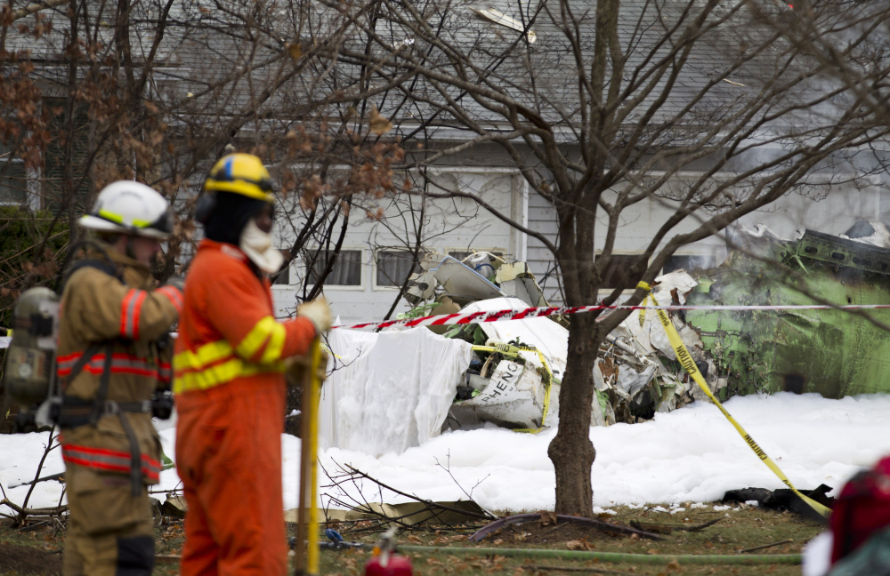 The wreckages of a small plane sits in a house driveway after crashing in Gaithersburg, Md., Monday.