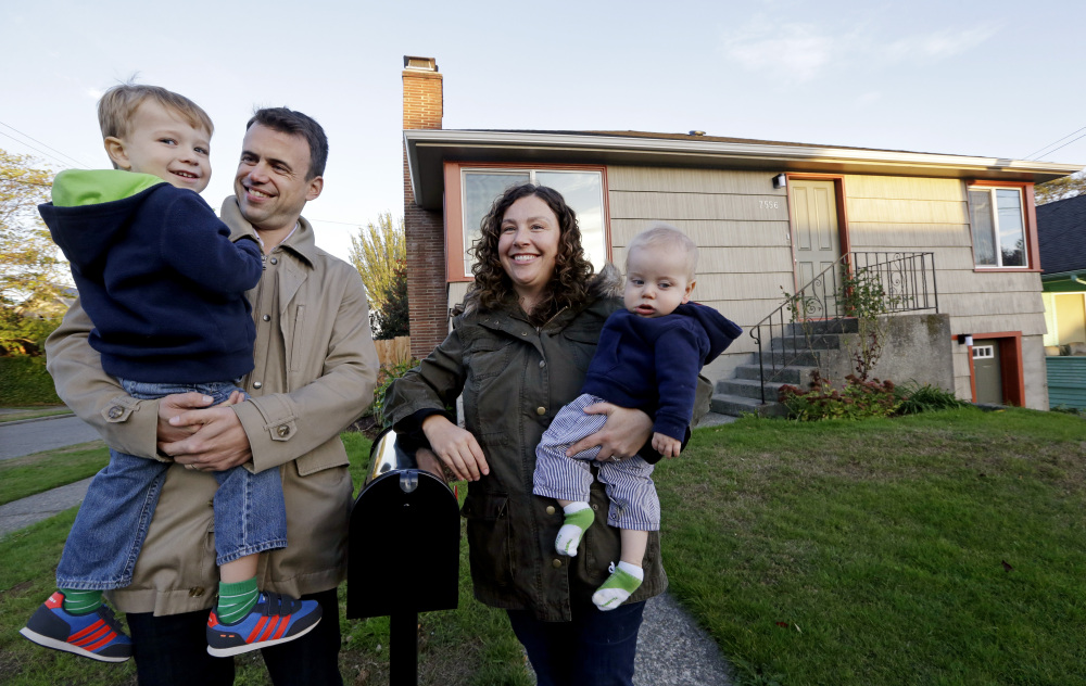 Jennifer Ewing and her husband, Florian Thiel, recently bought a house in Seattle near an elementary school for their children Max, left, and Felix. The couple figured housing would be affordable when they left New York City but instead bought the house for nearly $500,000.