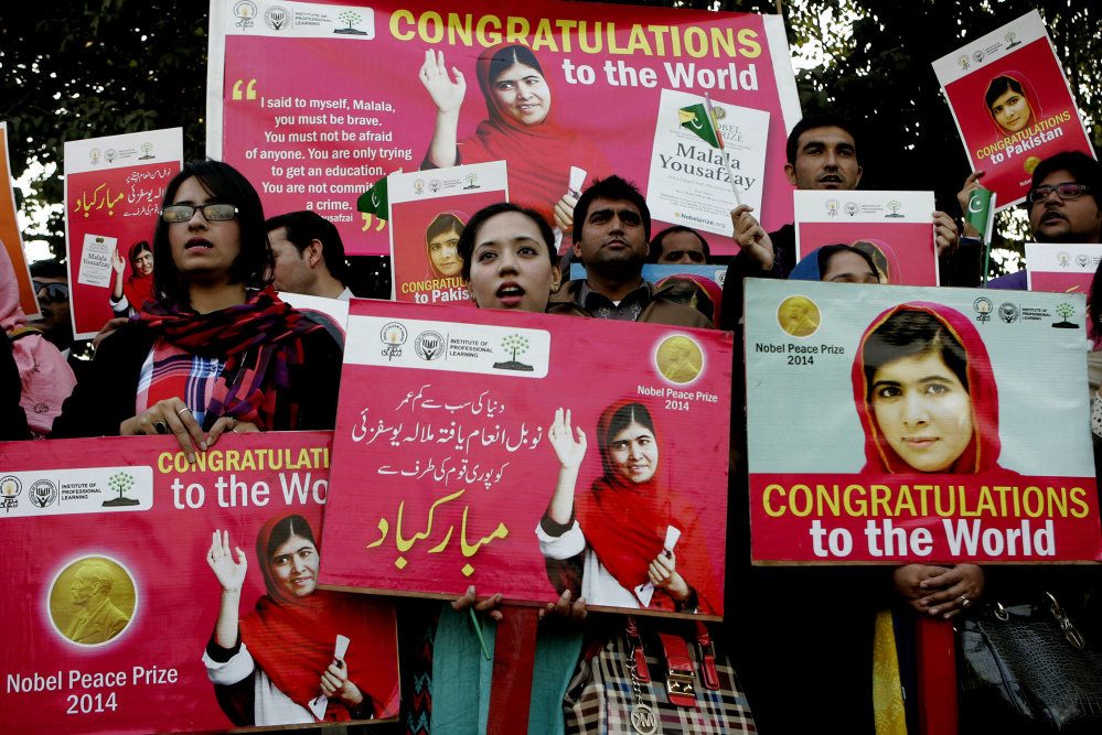 Pakistani students pay tribute to Nobel Peace Prize laureate Malala Yousafzai in Lahore, Pakistan, Wednesday.
