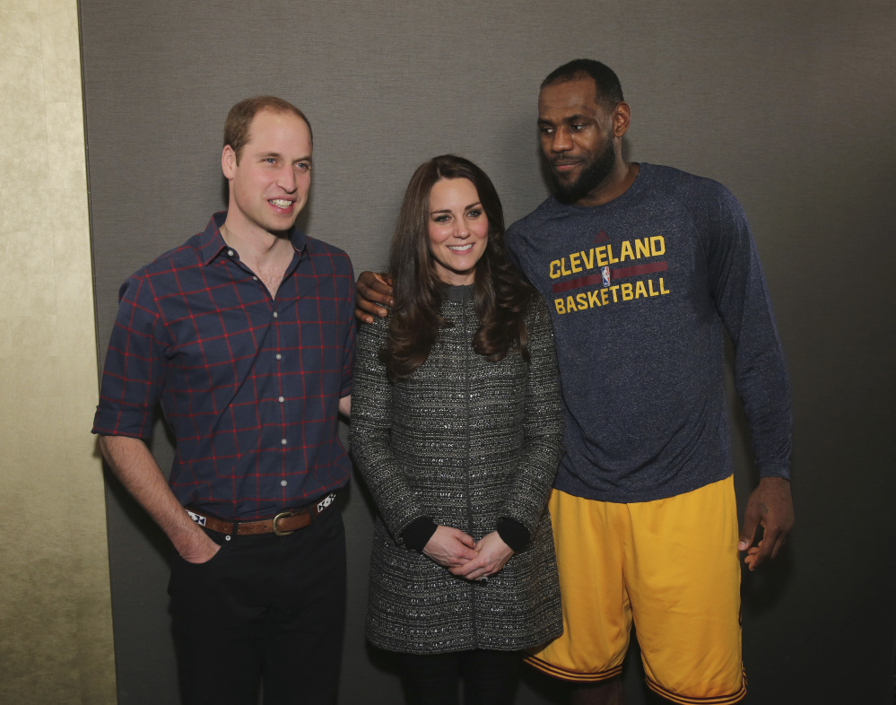 Britain’s Prince William, left, and Kate, Duchess of Cambridge, pose with LeBron James after Monday’s game between the Cleveland Cavaliers in New York. Britain’s Daily Mirror wrote, “James raised more than a few eyebrows when he got up close with Kate, still dressed in a soggy sweater.”