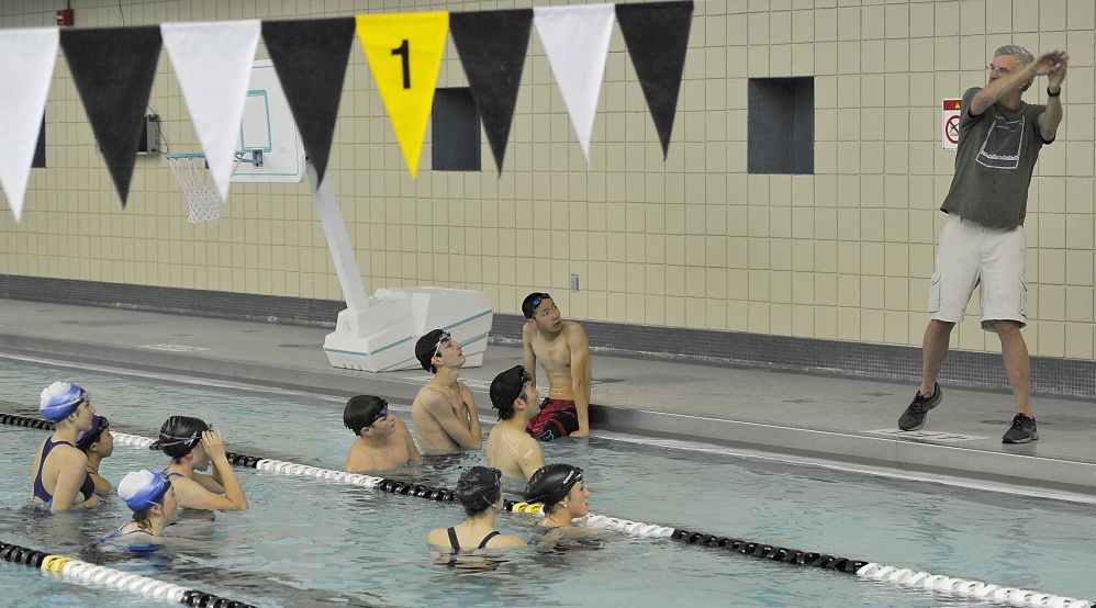 Brunswick High swimming coach David Bright teaches proper stroke techniques to the novice group as the team practices at Leroy Greason Pool on the Bowdoin College campus in Brunswick. The Dragons are expected to be among the best teams in the state.
