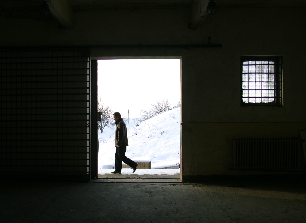 A journalist walks past a building inside the Mihail Kogalniceanu Airbase in Bucharest, Romania, in 2005. The airbase was indicated by Human Rights Watch as a possible location for a covert CIA prison allegedly used to interrogate terrorist suspects.