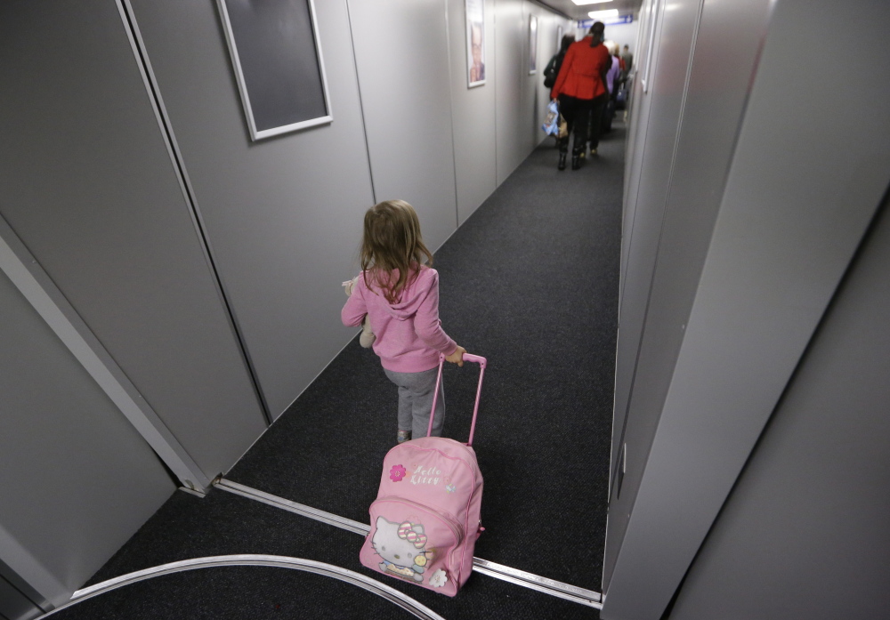 Symphony Rader, 4, pulls a bag down the boarding ramp last month at Love Field in Dallas. The first flight of the day sets the tone for keeping flights running on time.