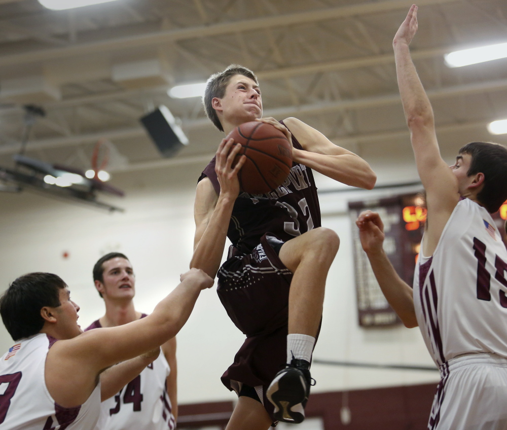 Freeport’s Nate Pelletier finds himself surrounded by a tenacious Greely defense that includes Chris Goding during Wednesday night’s loss to the Rangers.