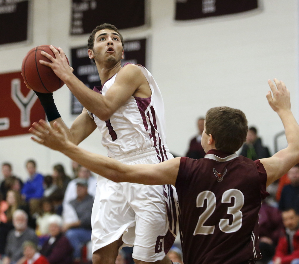 Greely’s Gabe Axelsen looks to shoot over Freeport’s Jack Davenport in Wednesday night’s game in Cumberland, won by the Rangers.