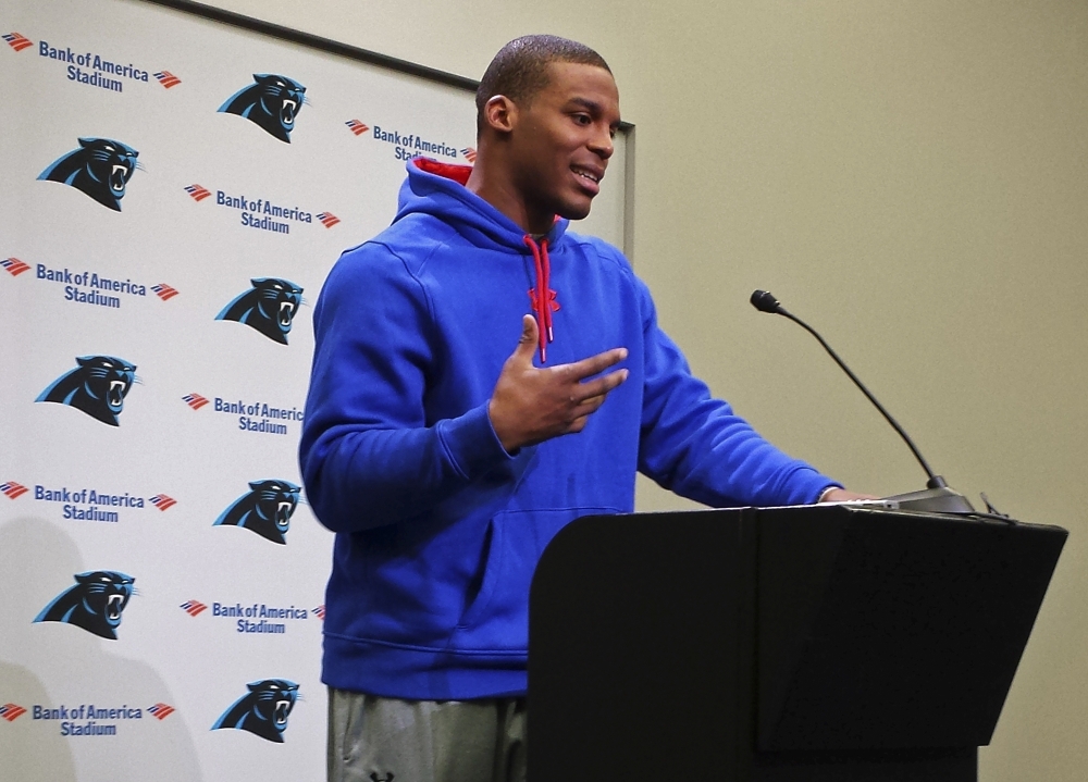 Carolina Panthers quarterback Cam Newton speaks to the media in Charlotte, N.C., on Thursday. Newton, who was injured Tuesday in a car crash, said he went to the team’s stadium to ease people’s minds, including his own.