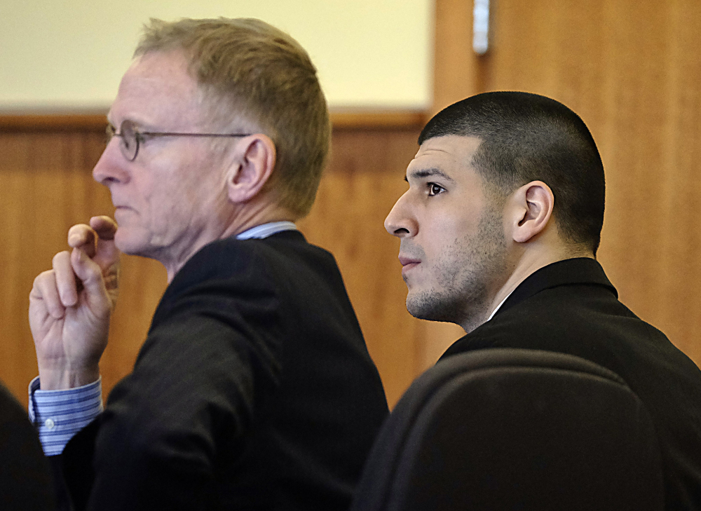 Aaron Hernandez listens with his attorney Charles Rankin, left, during a pre-trial motion hearing in Superior Court in Fall River, Mass., on Friday. Judge Susan Garsh ruled that prosecutors in the murder case against Hernandez may not tell jurors about two other killings with which the he is charged.
AP Photo/The Boston Globe, Robert E. Klein