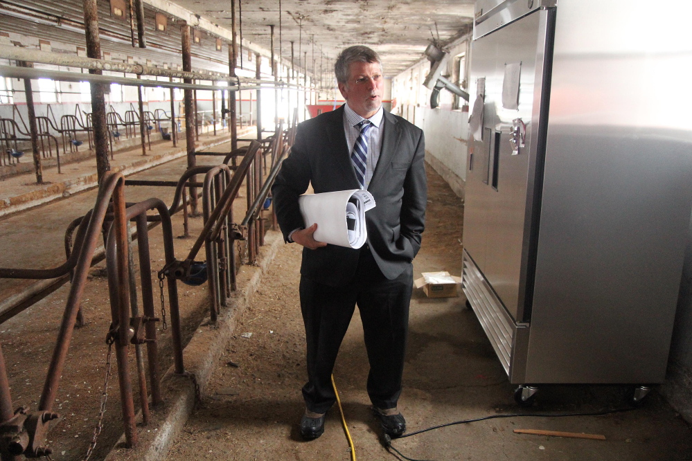 Kennebec Valley Community College President Richard Hopper stands inside an old dairy barn that will soon be converted to a field-based education center and food processing facility at the Harold Alfond Campus in Hinckley as part of the school’s sustainable agriculture program.