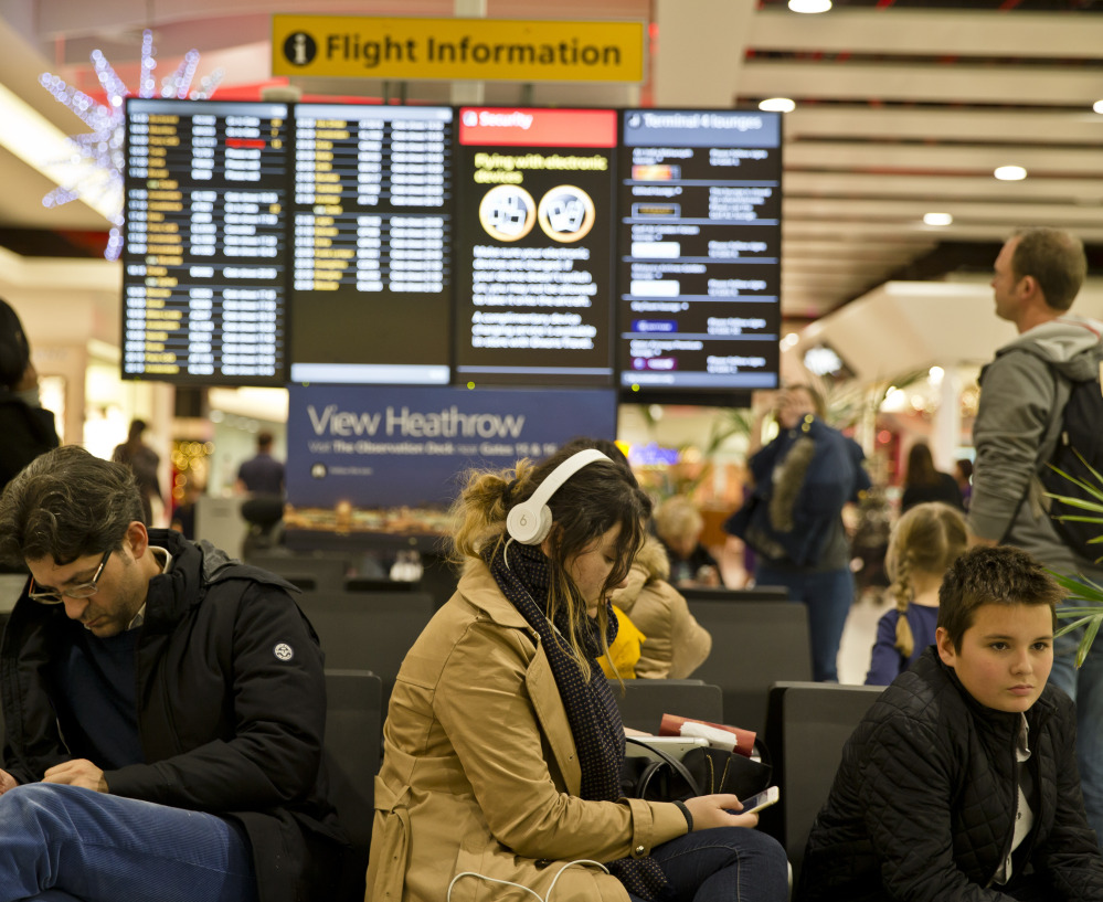 Passengers wait for flights to take off at Heathrow Airport in London after the city’s airspace was closed for a time on Friday because of a computer failure.