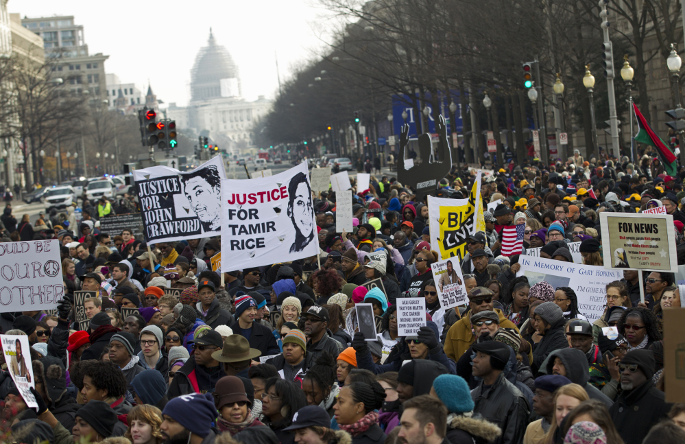 Demonstrators chant at Freedom Plaza in Washington, Saturday, Dec. 13 during the Justice for All rally.