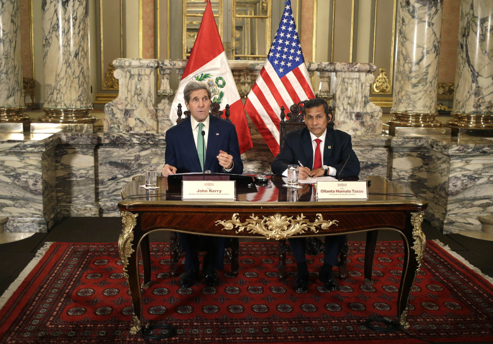U.S. Secretary of State John Kerry, left, speaks to the press as he sits with Peru's President Ollanta Humala after a private meeting at the government palace in Lima, Peru, on Thursday. Kerry is in Lima, along with delegates from more than 190 countries, to work on drafts for a global climate deal that is supposed to be adopted next year in Paris. The Associated Press