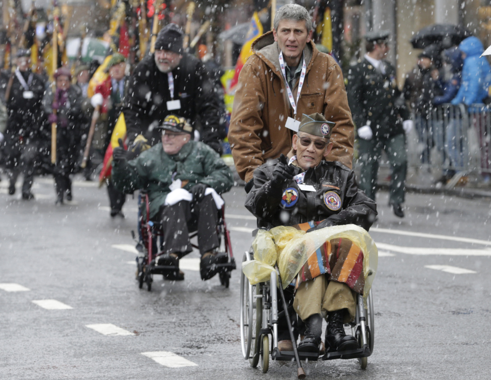 U.S. WWII veteran Bob Izumy of the 101st AB 506, participates in a parade during the 70th anniversary of the Battle of the Bulge in Bastogne, Belgium, Saturday.