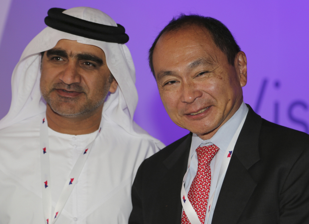Francis Fukuyama, an American political scientist, political economist and author, right, poses for a photo with an Emirati official at the Arab Strategy Forum in Dubai, United Arab Emirates, on Sunday. Abdullah al-Badri, the secretary-general of OPEC, is urging Gulf Arab nations to continue investing in oilfield development despite the sharp slide in crude prices.