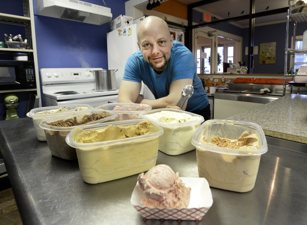 Andrew Warren displays some of the ice cream he serves at his Catbird Creamery in Westbrook. He and his wife, Corey DiGirolamo, have created a variety of enticing flavors.