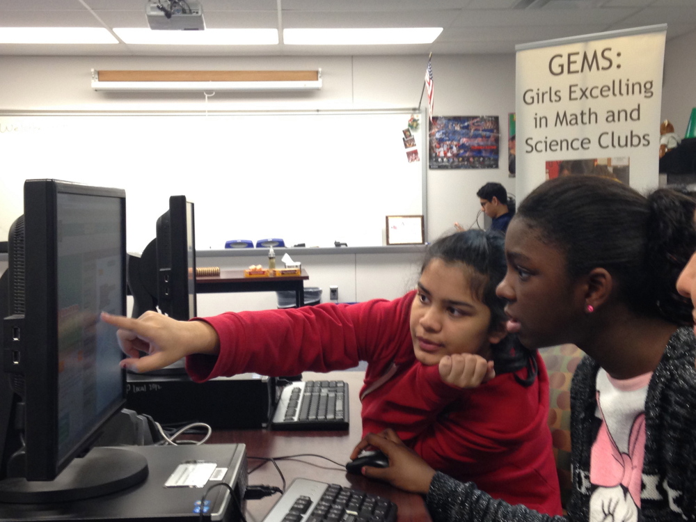 Pradeeti Mainali, 13, left, and Brieauna Johnson, 12, both students at Langston Hughes Middle School in Reston, Va., learn how to code at the GEMS (Girls Excelling in Math and Science) Hour of Code class at South Lakes High School in Reston.