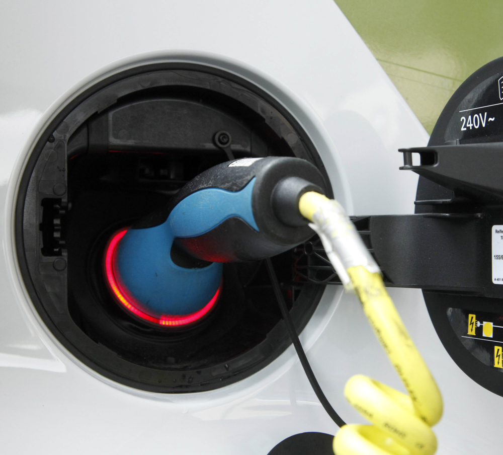 An electric car is charged with a plug. Researchers say all-electric cars are only as environmentally friendly as are their power sources. And  ethanol isn’t so green.