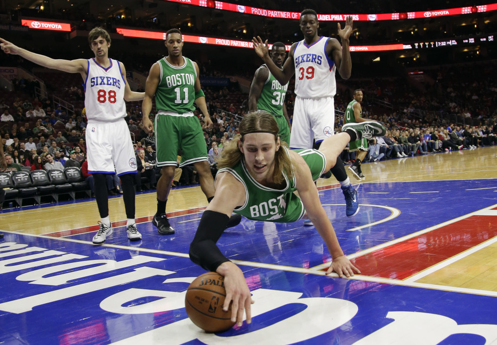 The Boston Celtics’ Kelly Olynyk dives for a loose ball during the first half of Monday night’s game against the Philadelphia 76ers. He scored a career-high 30 points in the Celtics’ win.