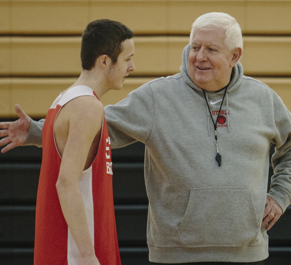 Harvey Moynihan talks to Sam Freeman during practice Monday at Scarborough High School. Moynihan, who won over 300 games as a boys’ basketball head coach, joined the Scarborough staff as an assistant this year.