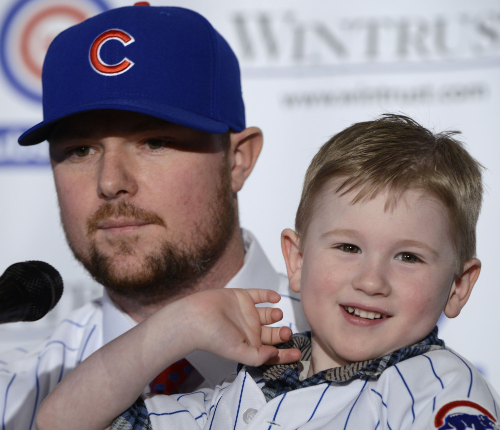 New Chicago Cubs pitcher Jon Lester, seen with his son, Hudson, was a part of two World Series titles with the Red Sox – something the Cubs believe they can accomplish.