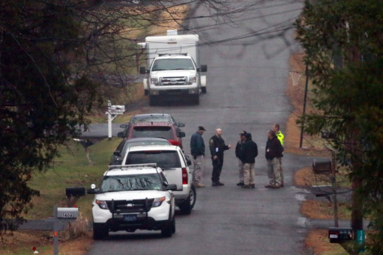 Investigators gather in a wooded area of Pennsburg, Pa., near where the body of Bradley William Stone was discovered Tuesday. The Iraq War veteran who was suspected of killing his ex-wife and five of her relatives was found dead in the woods near his home after a day-and-a-half manhunt.