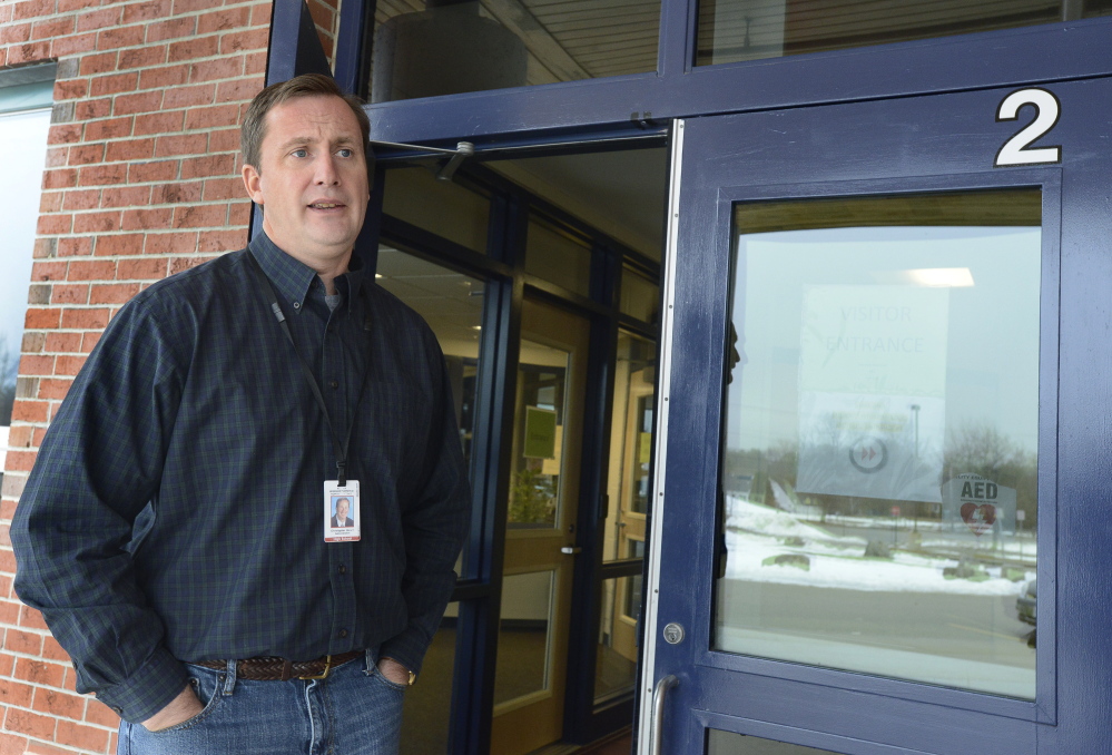 Windham High School Principal Christopher Howell speaks briefly Tuesday outside the locked school doors. He and the custodial staff were the only people in the building, he said.