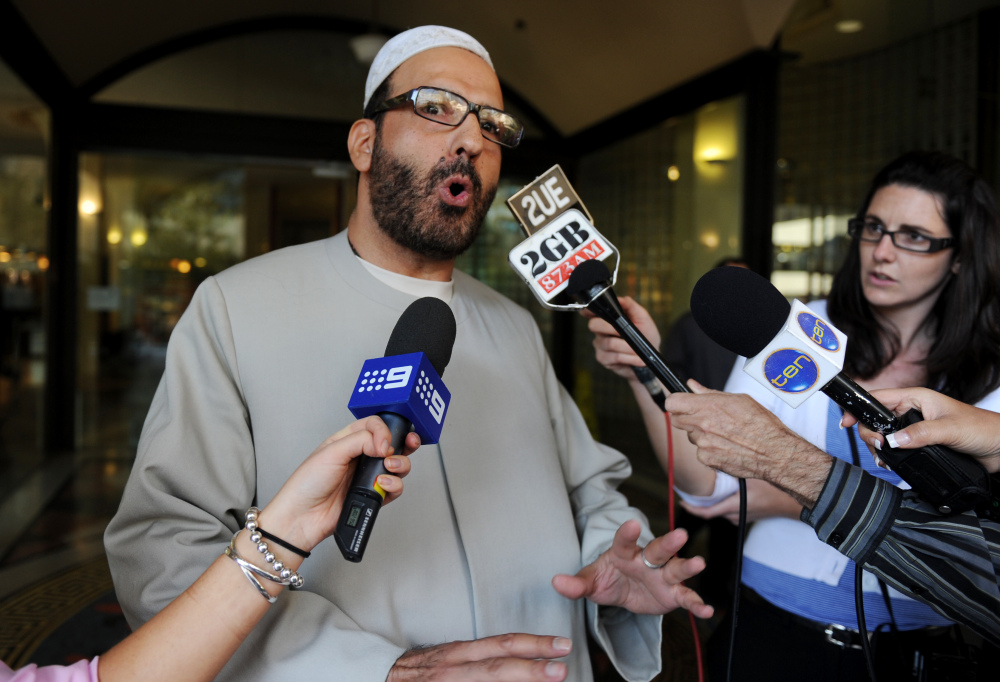 In this April 18, 2011 file photo, Man Haron Monis speaks to the media as he leaves the Downing Centre in Sydney after a pre-trial hearing where he is accused of sending offending letters to the families of soldiers killed in Afghanistan.