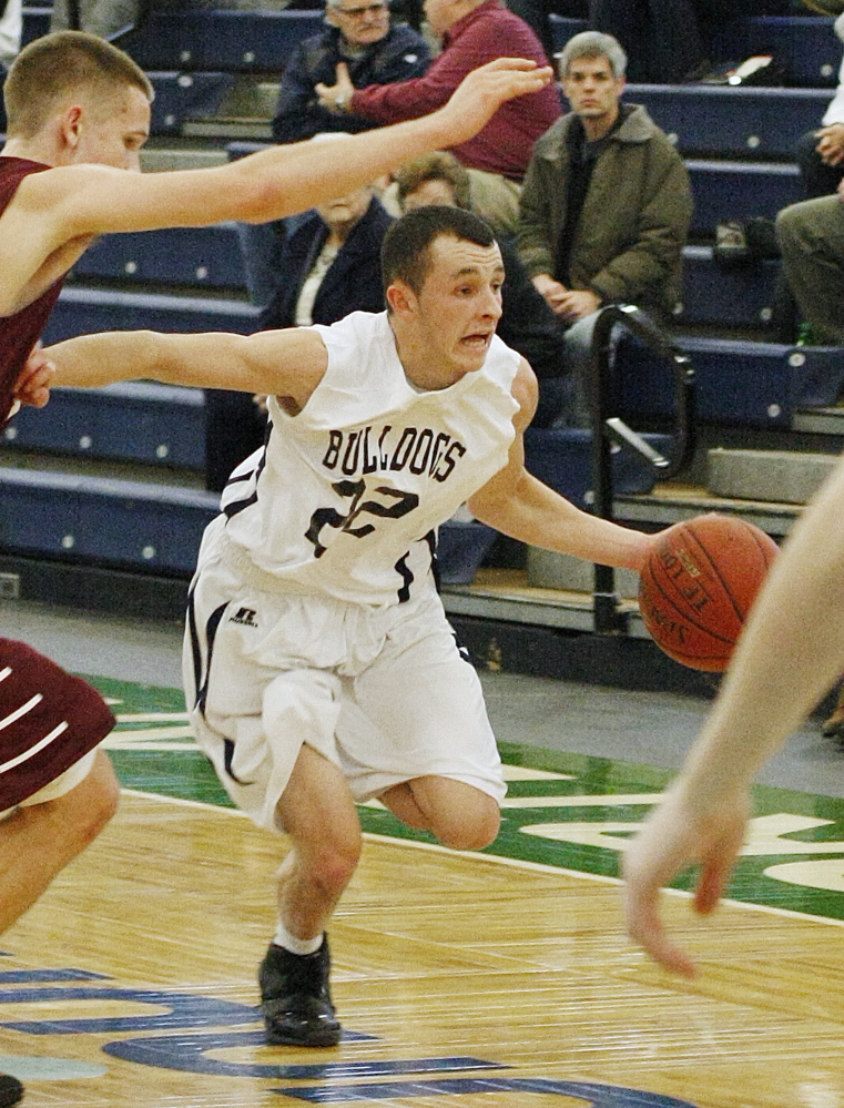 Liam Densmore moves past Gorham’s Billy Ruby during the first half of Portland’s victory Tuesday night at Portland Expo. Densmore hit seven 3-pointers and finished with 31 points.