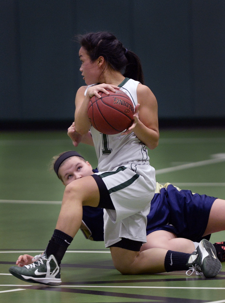 PORTLAND ME - DECEMBER 15: Waynflete's Helen Gray-Bauer comes up with a loose ball as Traip Academy's Cassidy Delano tries to get a hand on the ball Tuesday, December 16, 2014. (Photo by Shawn Patrick Ouellette/Staff Photographer)