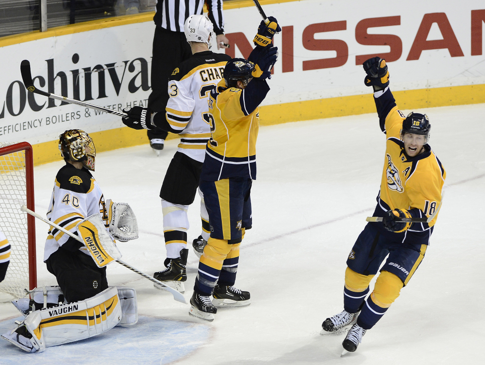 Nashville Predators center Mike Fisher, center, and James Neal celebrate after Fisher scored against Bruins goalie Tuukka Rask in the second period Tuesday night in Nashville, Tenn. The Bruins sent the game to overtime but lost in a shootout.