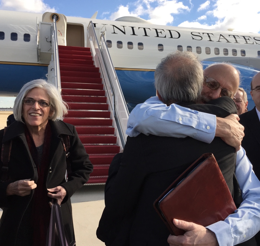 Alan Gross, facing camera, is hugged by Tim Rieser, an aide to Sen. Patrick Leahy, D-Vt., Wednesday at Andrews Air Force Base, Md., upon his arrival from Cuba. Gross's wife Judy is at left, Rep. Jim McGovern, D-Mass. is at right.