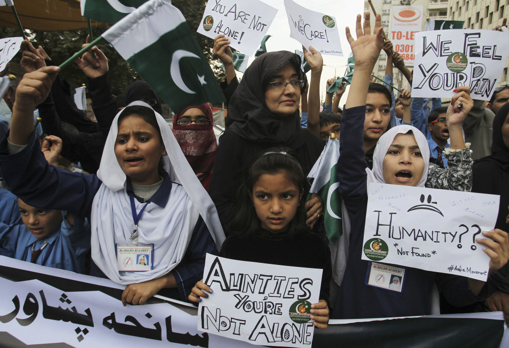 Pakistani students chant slogans to condemn to Tuesday’s Taliban attack on a military-run school in Peshawar, during a demonstration Wednesday in Karachi, Pakistan.